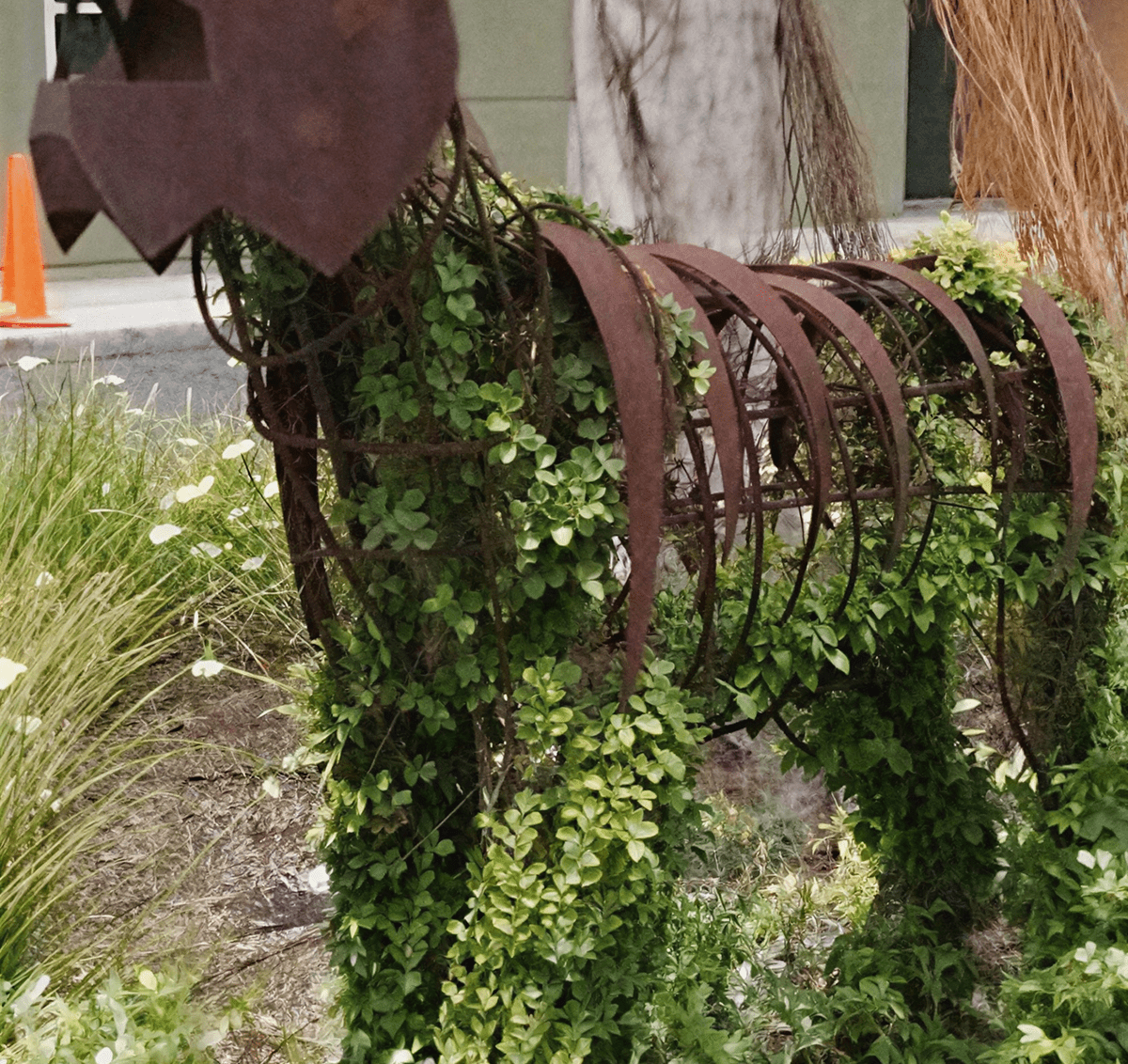 Metal sculpture covered with greenery