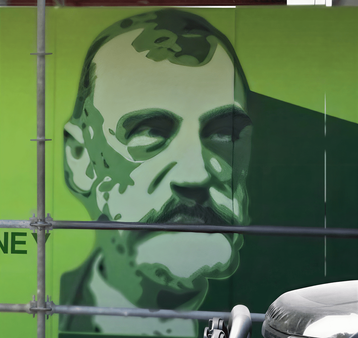 Artistic green-toned face mural outdoors