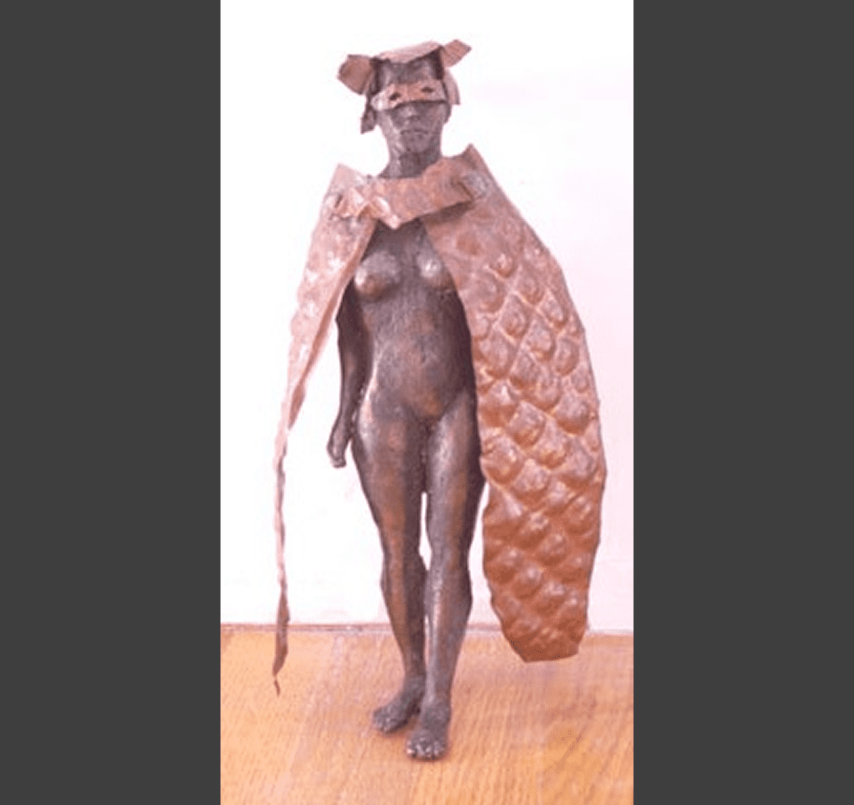 Artistic sculpture of a masked figure.
