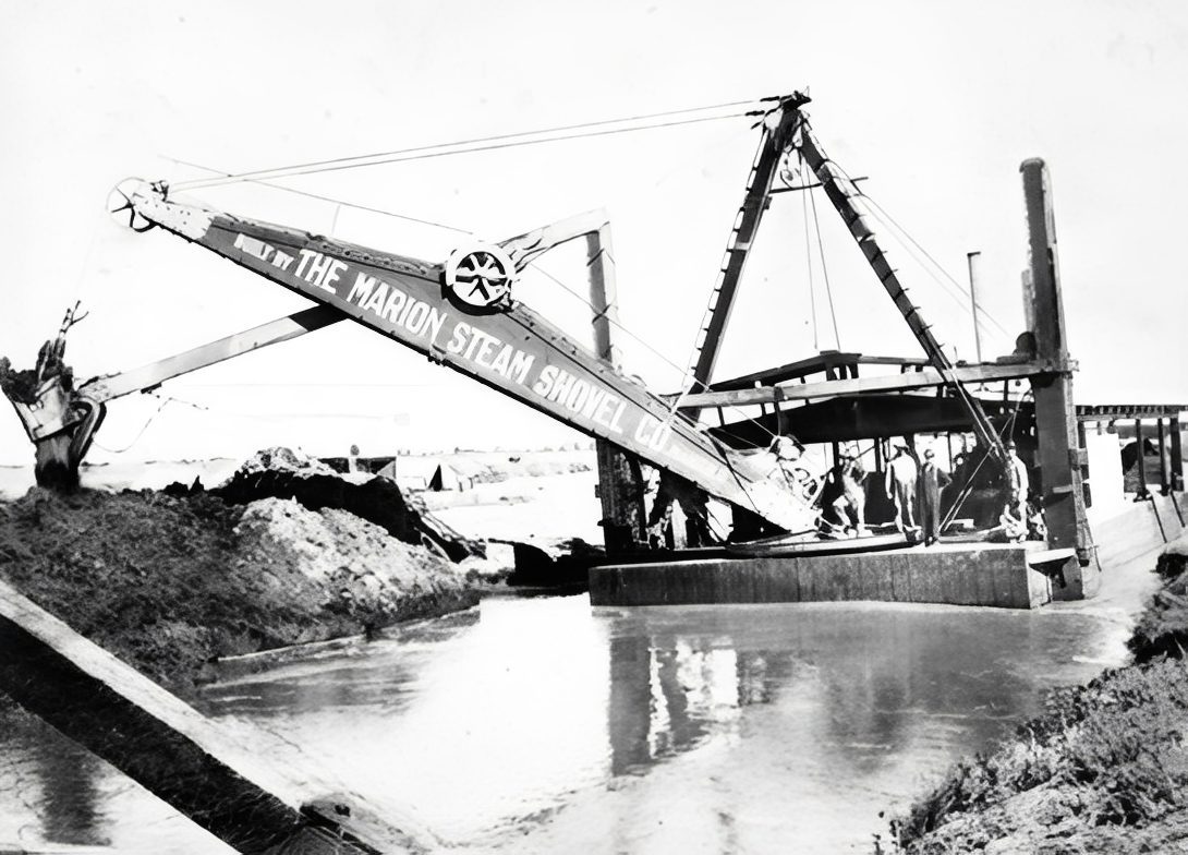 Historic steam shovel by a river