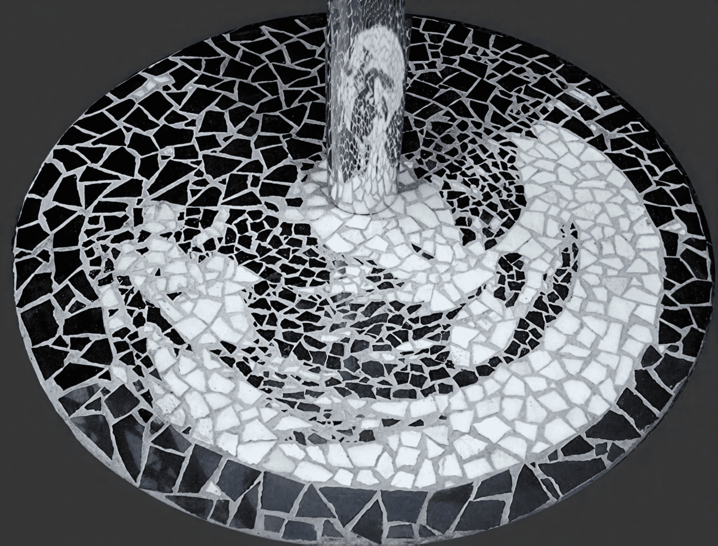 Mosaic floor with abstract black and white design.