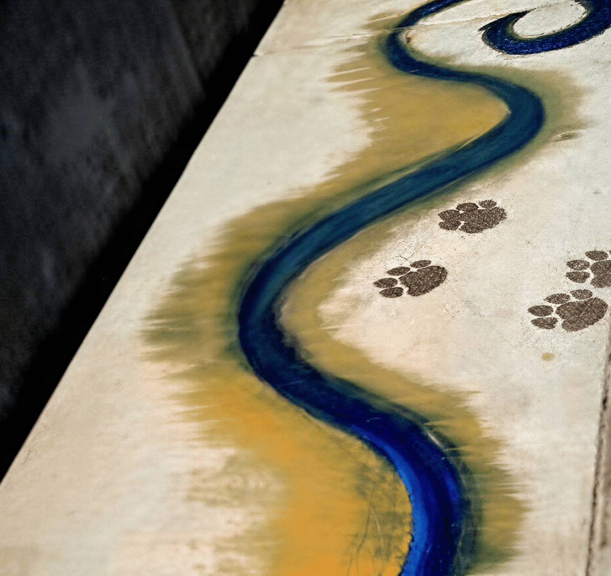 Artistic path with paw prints and swirl