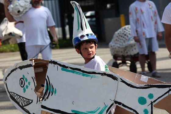 Boy wearing paper shark outfit and helmet