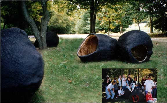 Large black sculptures in a park setting.