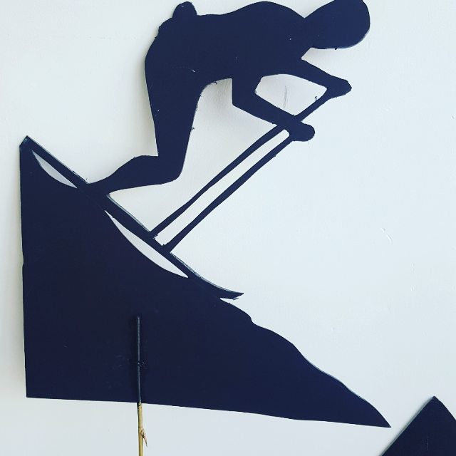 Silhouette of skier on a mountain slope.