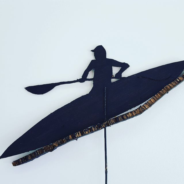 Silhouette of person kayaking wall art.