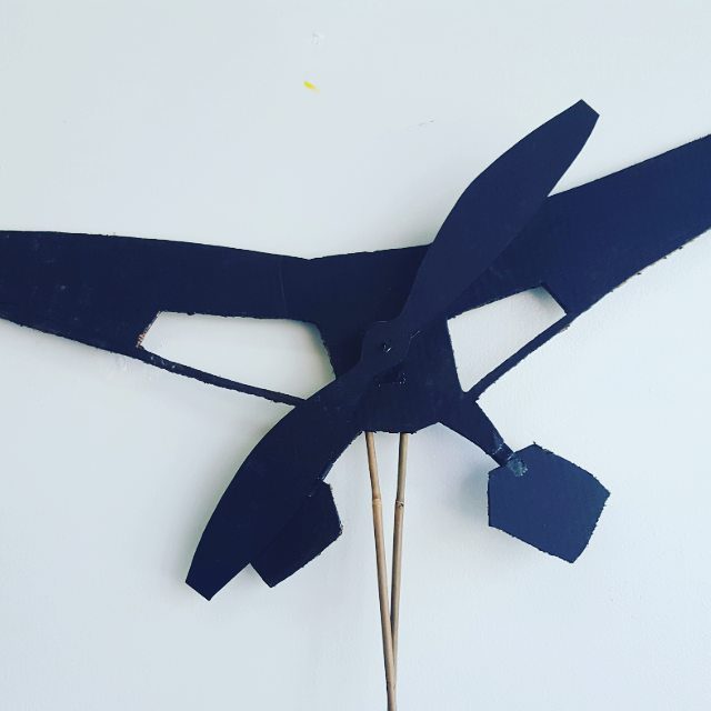 Black paper airplane model on white background.