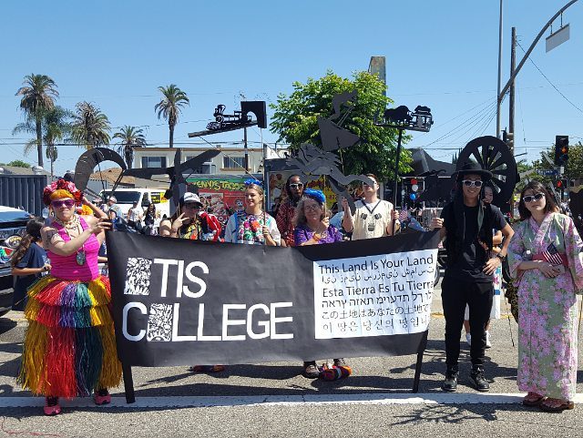 People holding a banner at a parade.