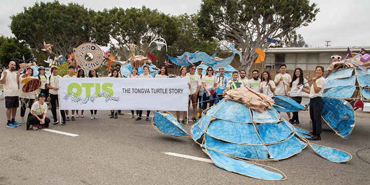 Parade group with large turtle decorations.