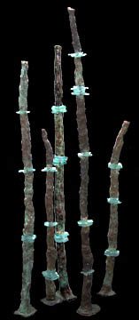 Tall, slender sculptures with turquoise accents.