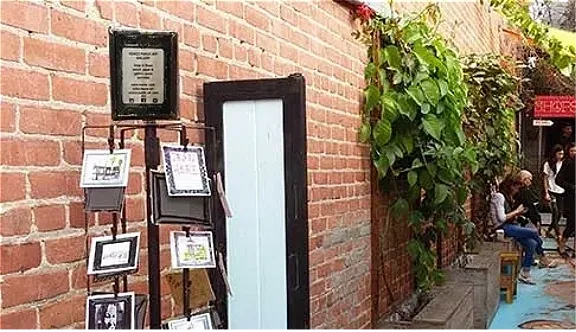 Brick wall, plant decor, and seating area.