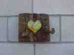 Heart-shaped lock on a wooden plank.
