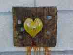 Rusty metal heart on wooden background.