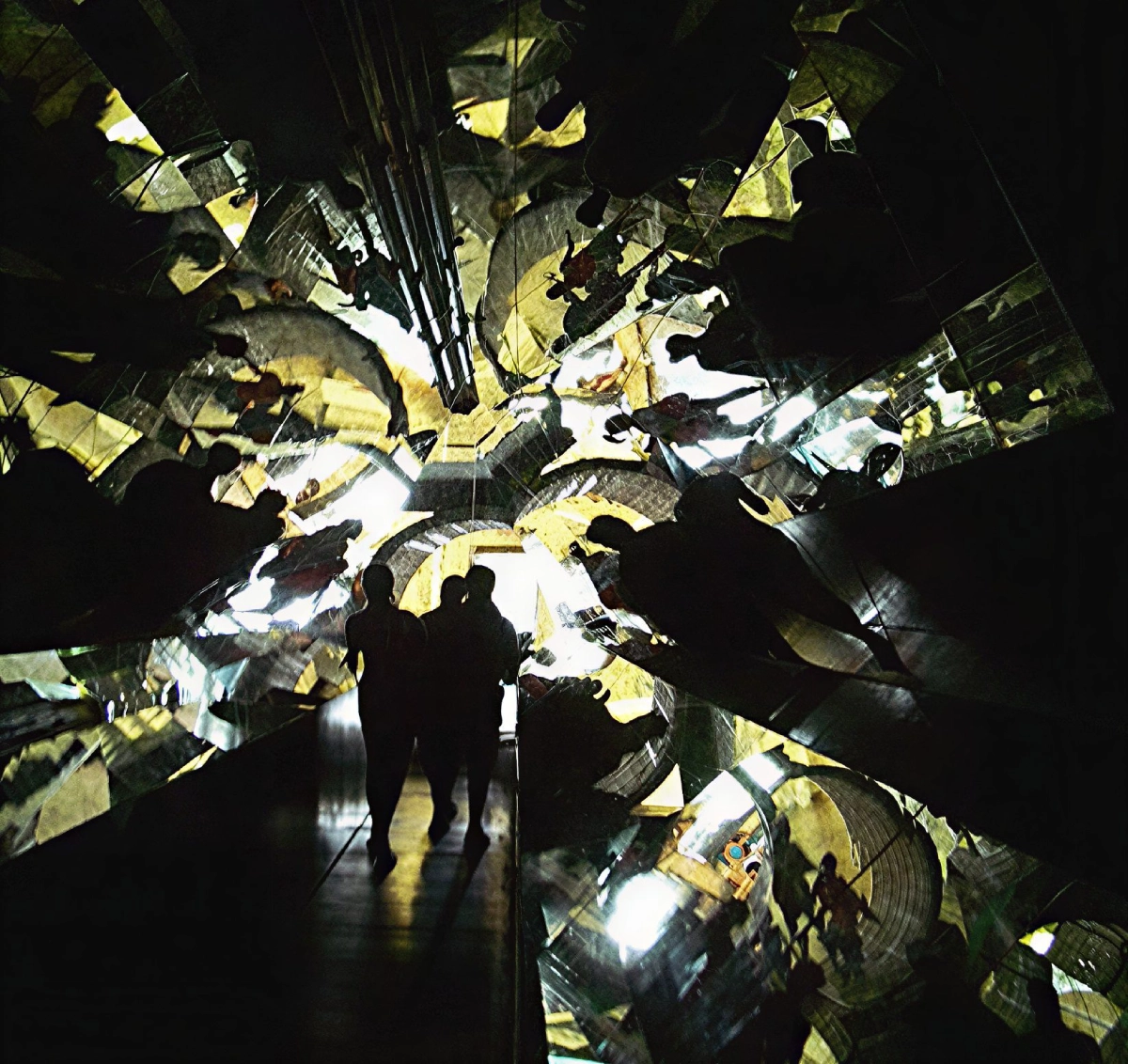Abstract mirrored reflections with silhouetted figures.