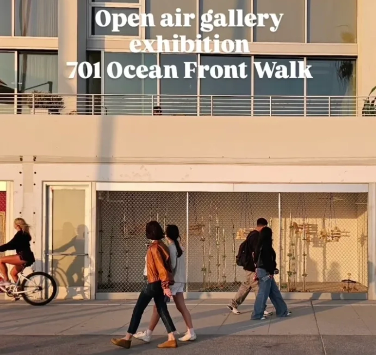 People walking by open air gallery exhibition.