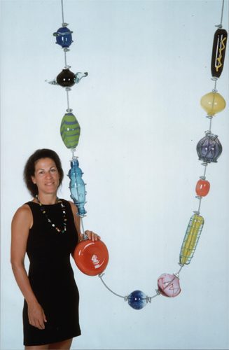 Woman with large, colorful bead necklace.