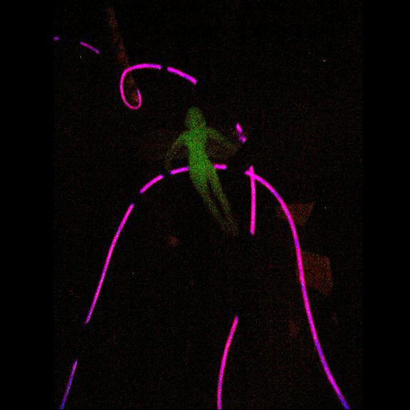 Glowing figure with neon lines in darkness.