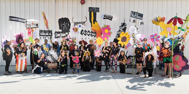 Group with colorful flower cutouts and banners.