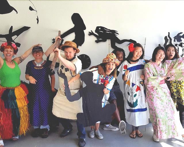 Group in colorful costumes posing joyfully together.