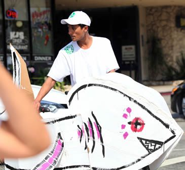 Person with large cardboard fish costume.