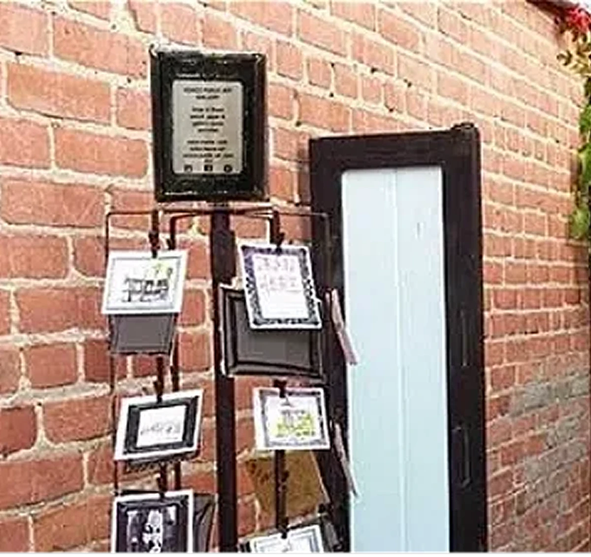 Postcard stand against brick wall background.