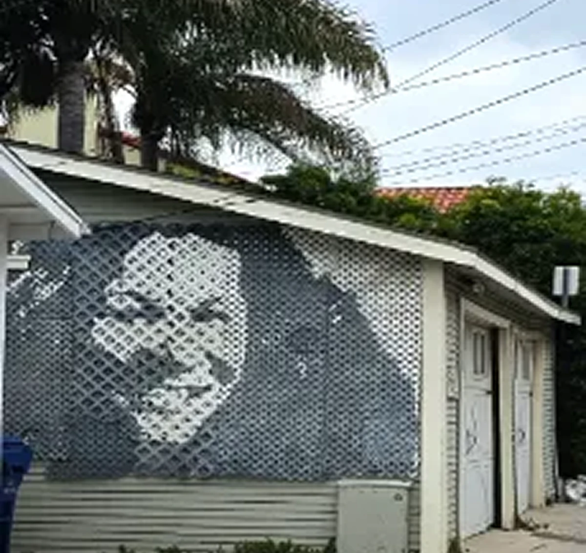 Mural of a smiling face on garage.