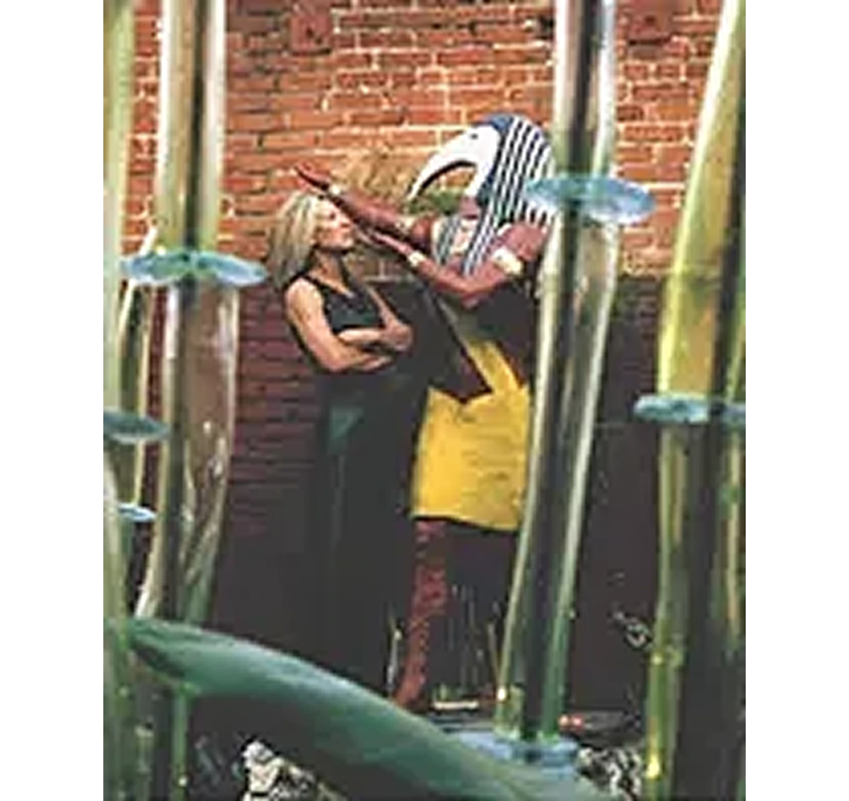 Person with Egyptian costume beside brick wall.