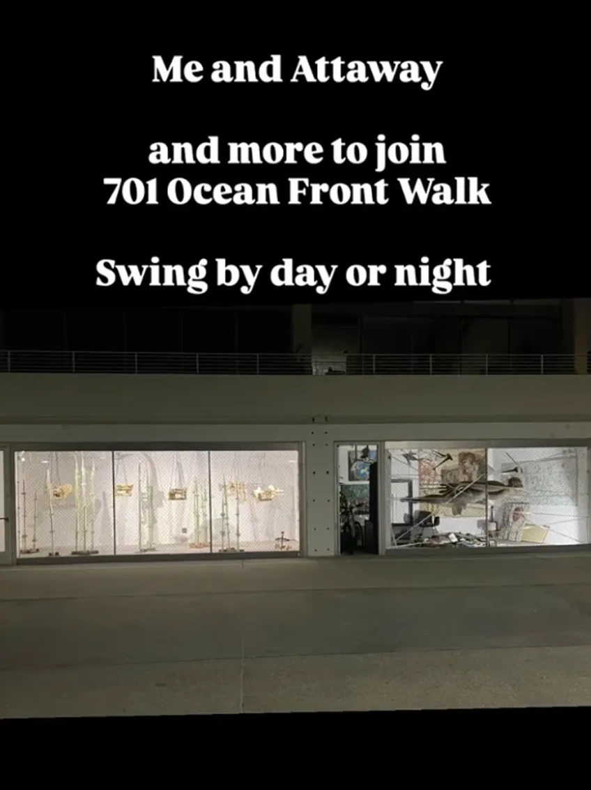 Storefront with invitation text at night.