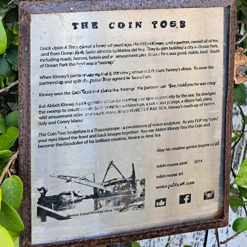 Sign about "The Coin Toss" sculpture story.