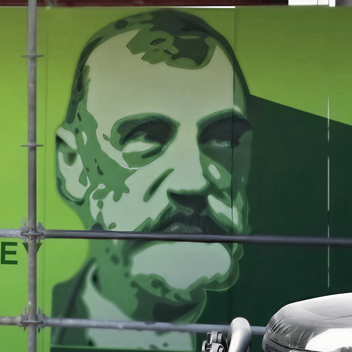 Artistic green-toned face mural outdoors