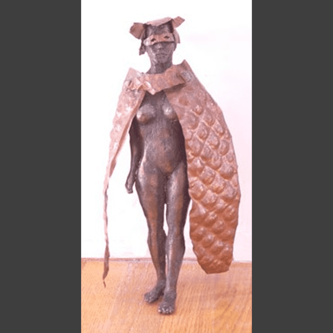 Artistic sculpture of a masked figure.
