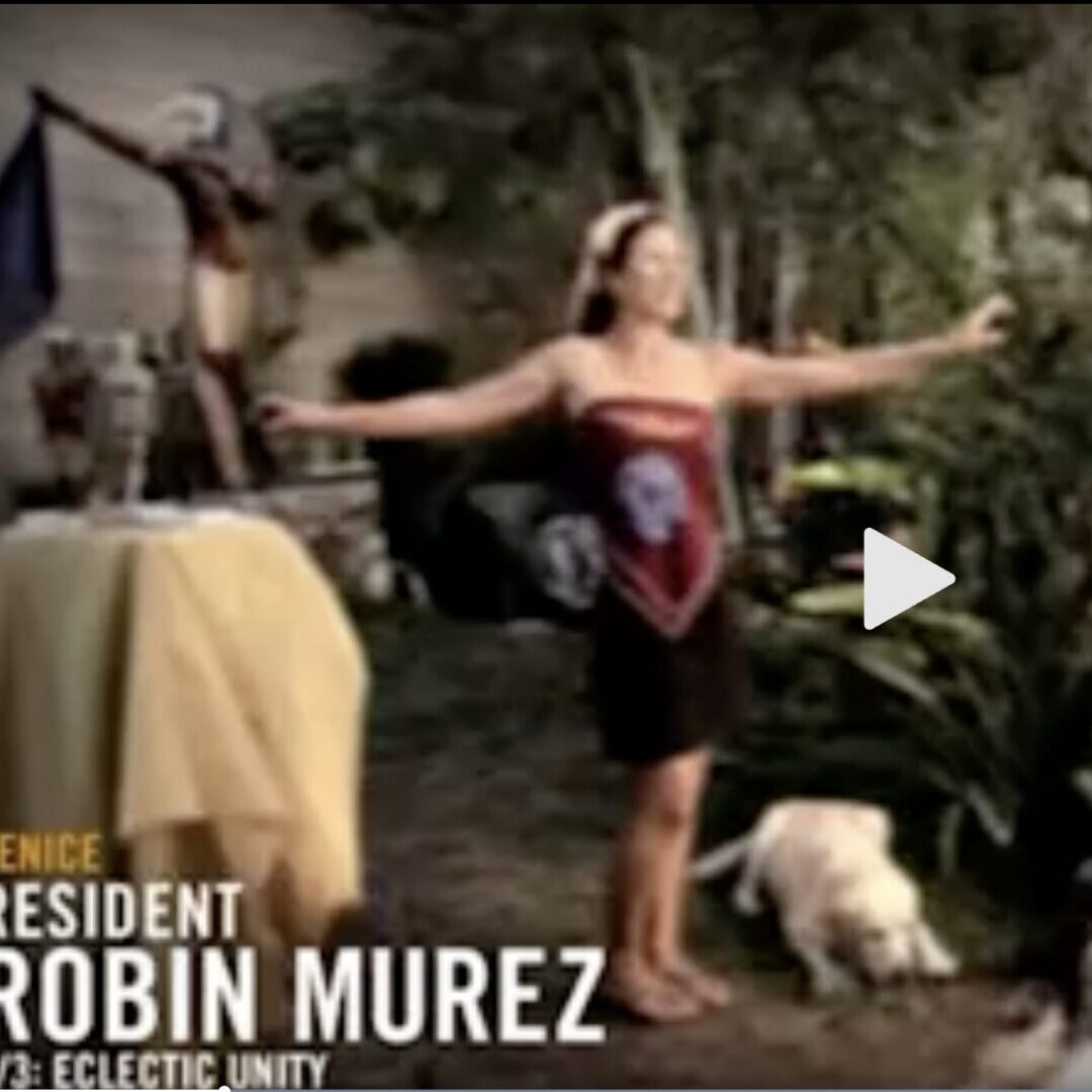Woman with outstretched arms, small dog nearby