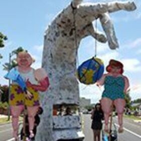 Giant hand parade float with two puppets