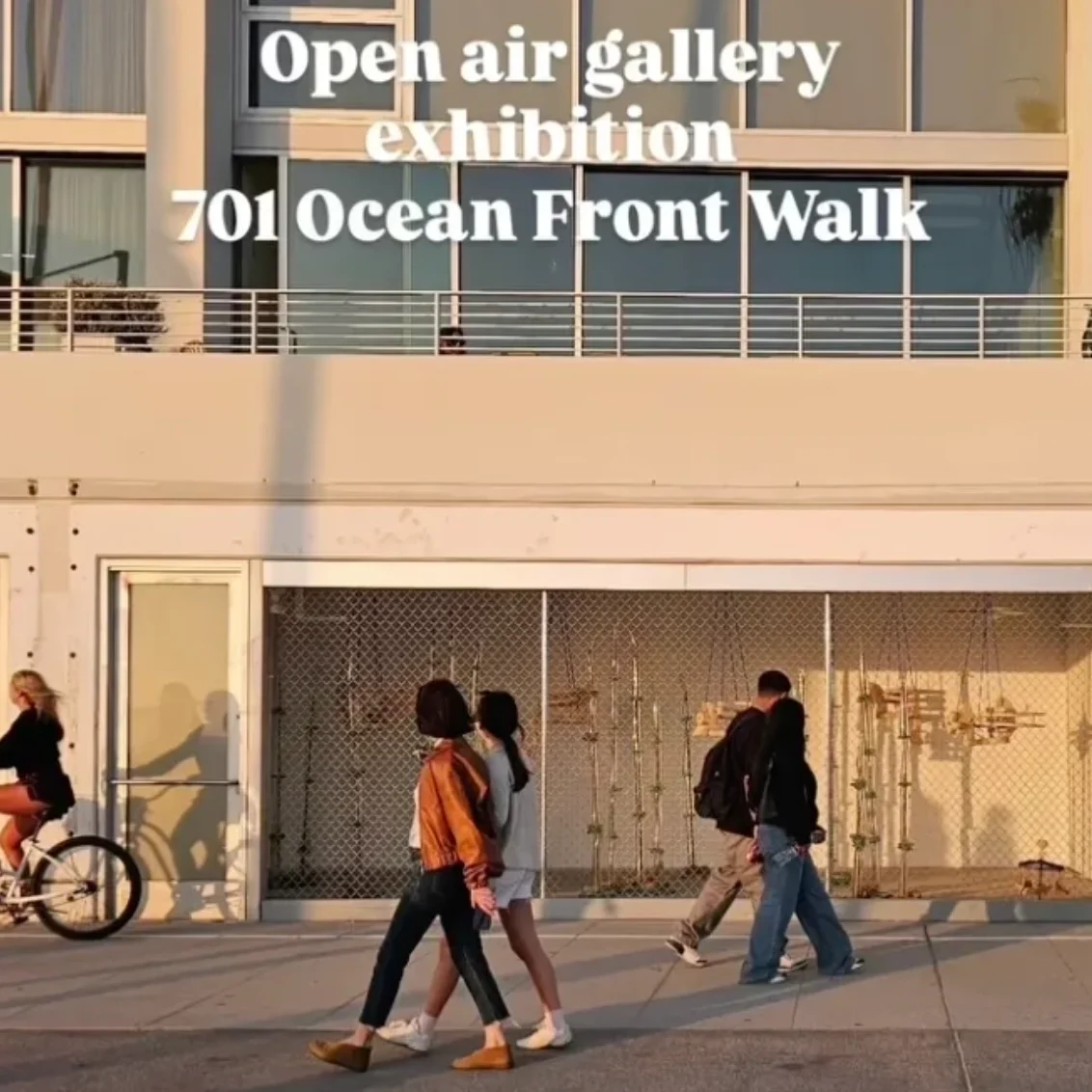 People walking by open air gallery exhibition.
