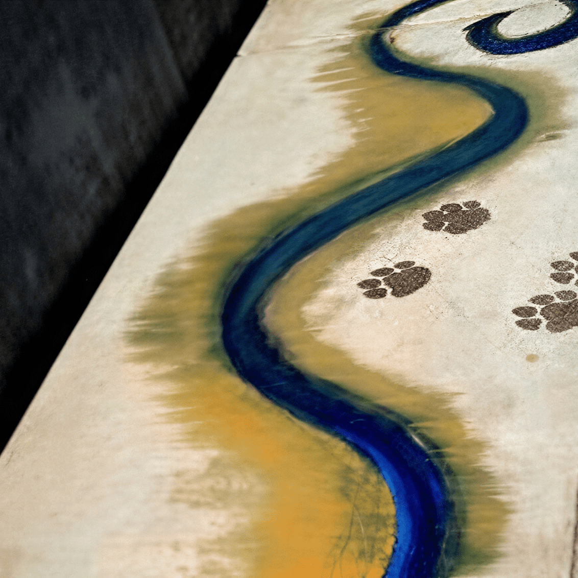 Artistic path with paw prints and swirl