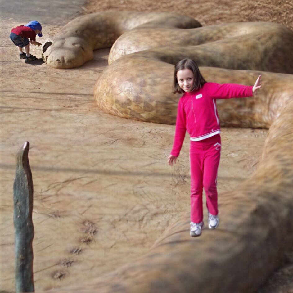 Kids playing on large snake statue